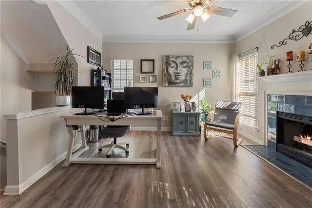 a living room with furniture a fireplace and a flat screen tv