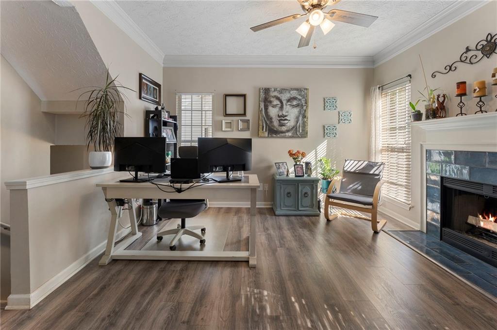 4074 Spring Cove Drive Duluth, GA 30097 - Photo 12 of 48 a living room with furniture a fireplace and a flat screen tv