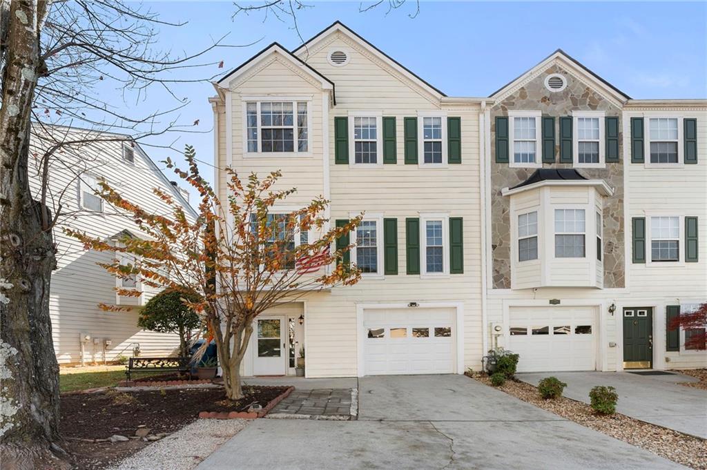 4074 Spring Cove Drive Duluth, GA 30097 - Photo 2 of 48 a front view of a house with a tree