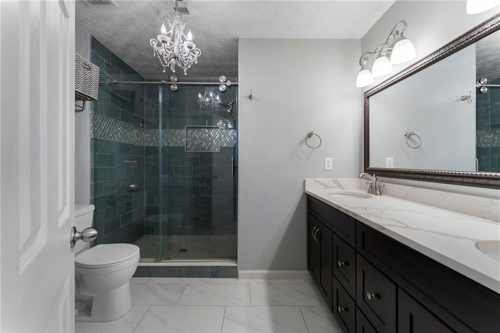 4074 Spring Cove Drive Duluth, GA 30097 - Photo 30 of 48 a bathroom with a double vanity sink toilet and shower