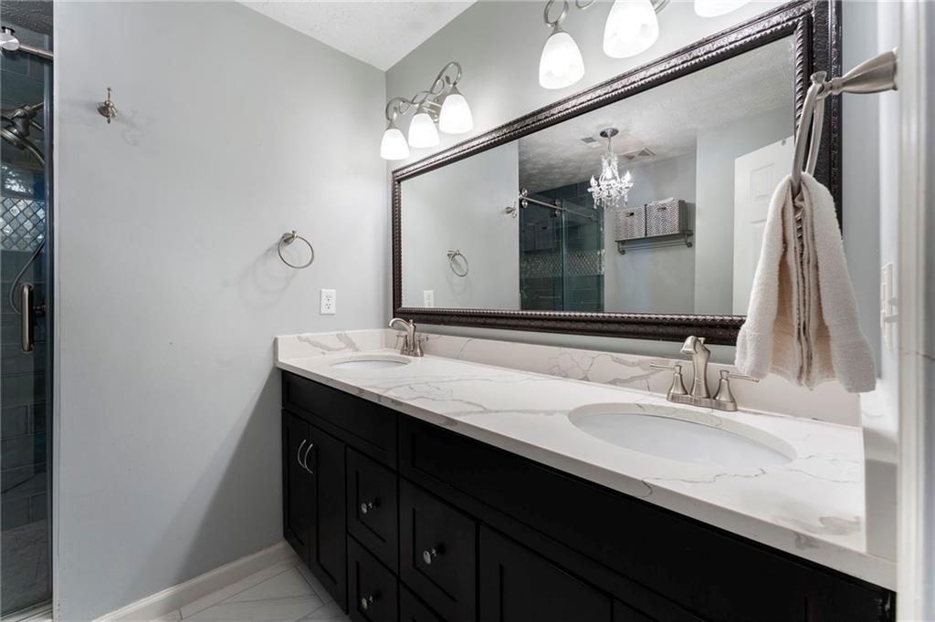 4074 Spring Cove Drive Duluth, GA 30097 - Photo 31 of 48 a bathroom with a double vanity sink and a mirror
