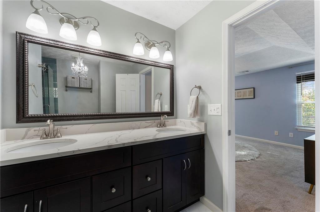 4074 Spring Cove Drive Duluth, GA 30097 - Photo 33 of 48 a bathroom with a double vanity sink and a mirror