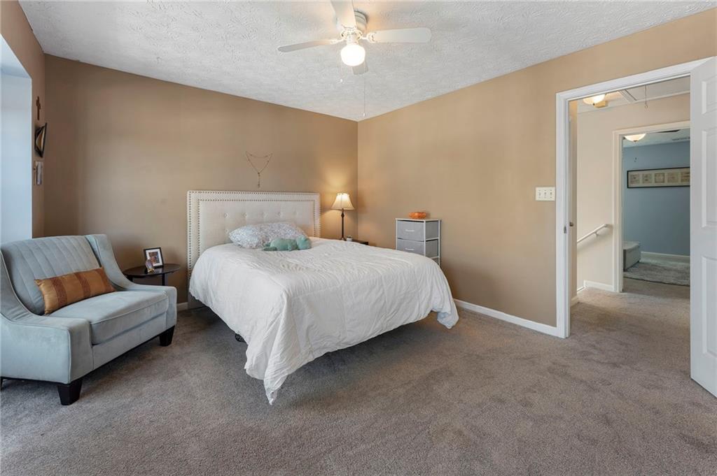 4074 Spring Cove Drive Duluth, GA 30097 - Photo 35 of 48 a bedroom with a bed and a couch