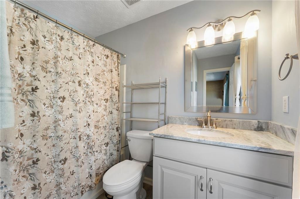 4074 Spring Cove Drive Duluth, GA 30097 - Photo 36 of 48 a bathroom with a granite countertop sink toilet and shower