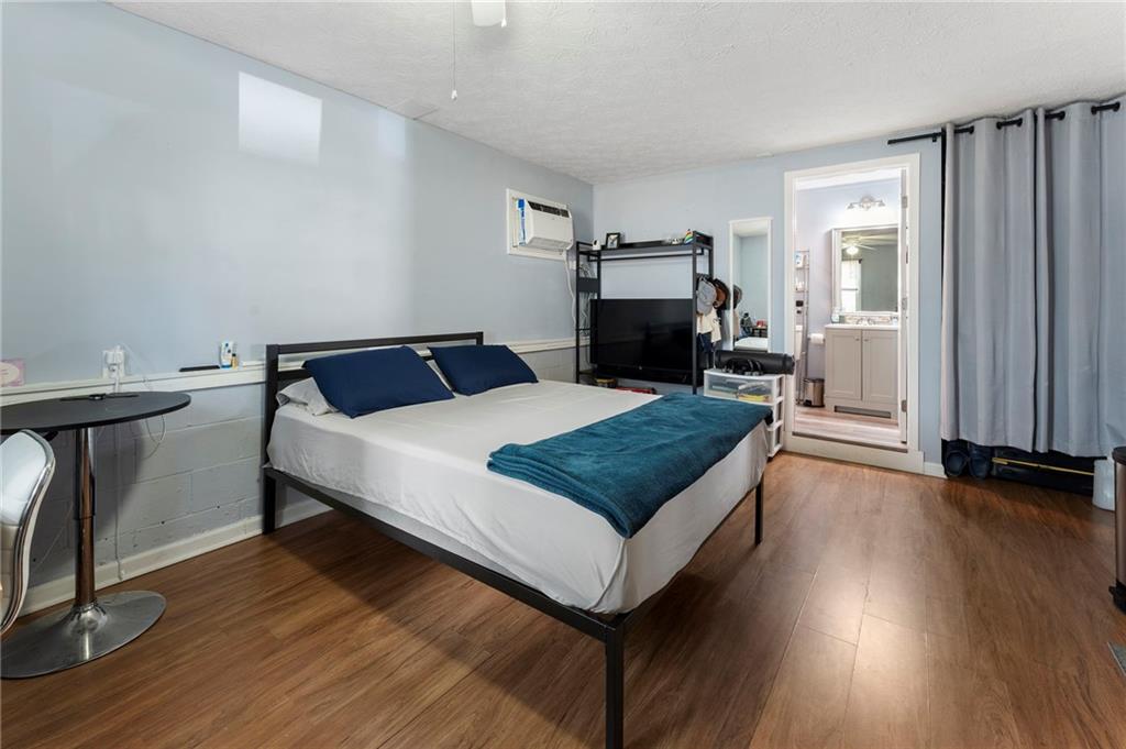 4074 Spring Cove Drive Duluth, GA 30097 - Photo 39 of 48 a bedroom with a bed and wooden floor