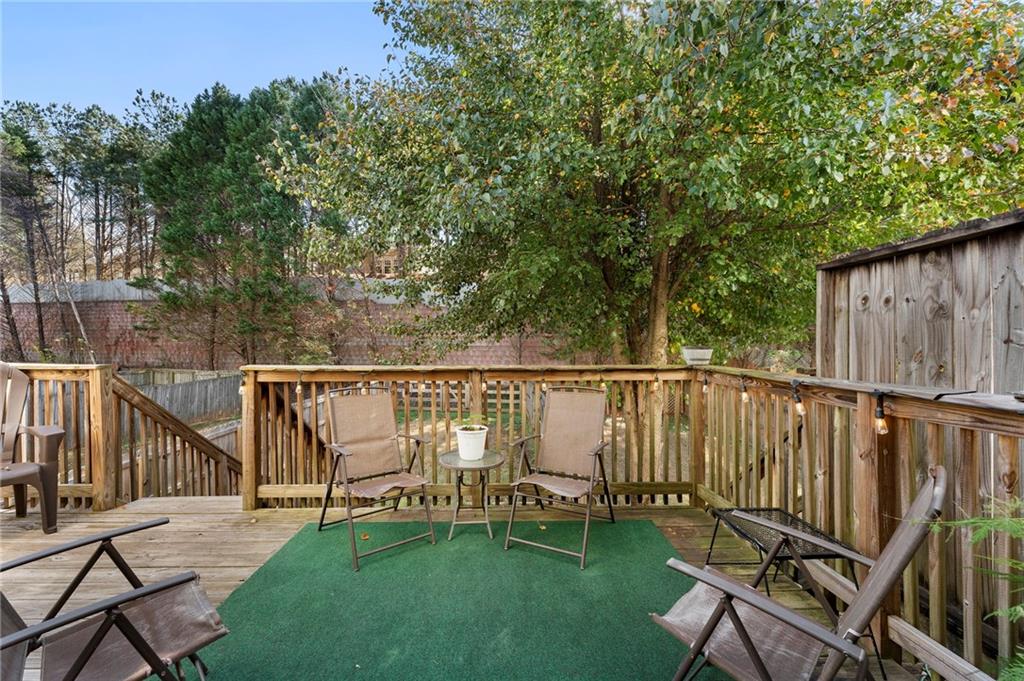 4074 Spring Cove Drive Duluth, GA 30097 - Photo 41 of 48 a balcony with wooden floor and outdoor seating