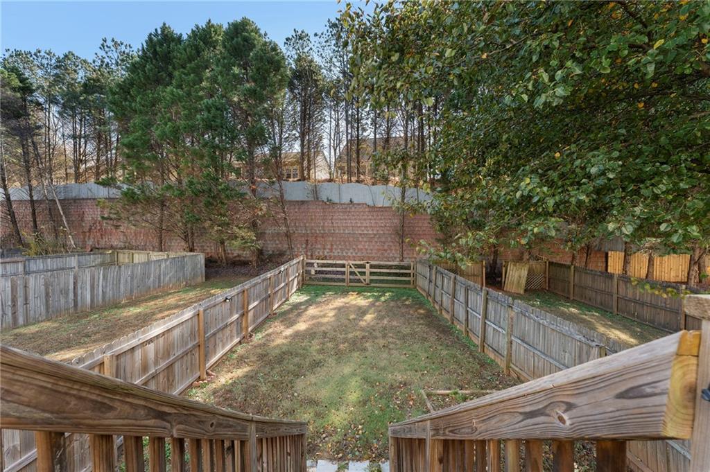 4074 Spring Cove Drive Duluth, GA 30097 - Photo 45 of 48 a backyard of a house with large trees and plants