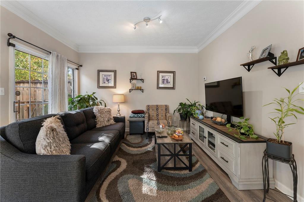 4074 Spring Cove Drive Duluth, GA 30097 - Photo 8 of 48 a living room with furniture and a flat screen tv