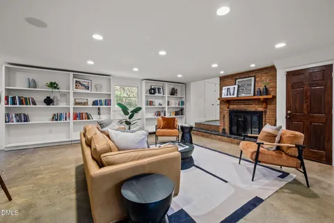 a living room with furniture and a fireplace
