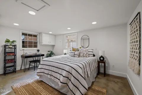 a bedroom with a large bed and a book shelf