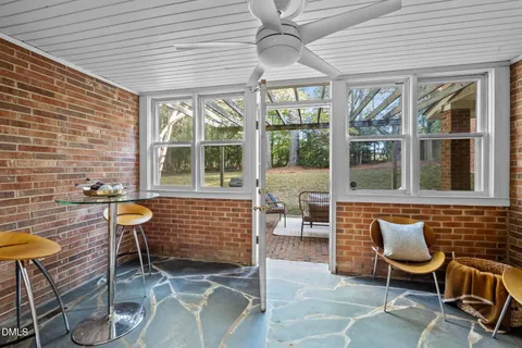 a front view of a house with outdoor seating