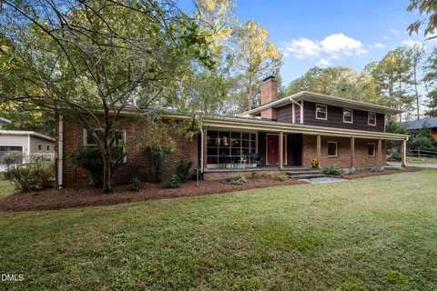 a front view of a house with swimming pool having outdoor seating