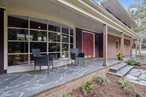 a front view of house with seating space and yard