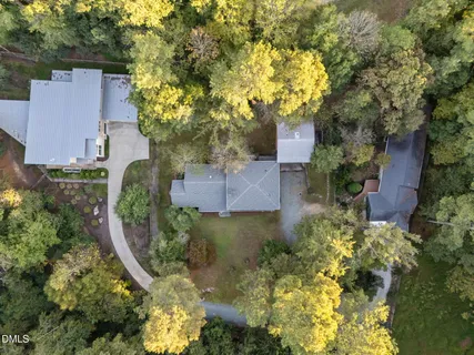 an aerial view of a house with a yard swimming pool and outdoor seating