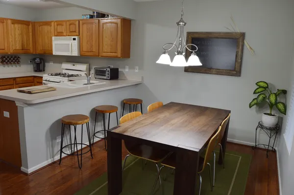 a kitchen with a table a sink a cabinets and appliances