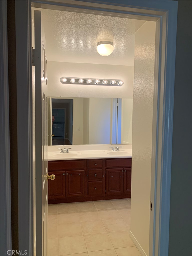 33782 Channel Street Temecula, CA 92592 - Photo 12 of 30 a bathroom with a double vanity sink and mirror