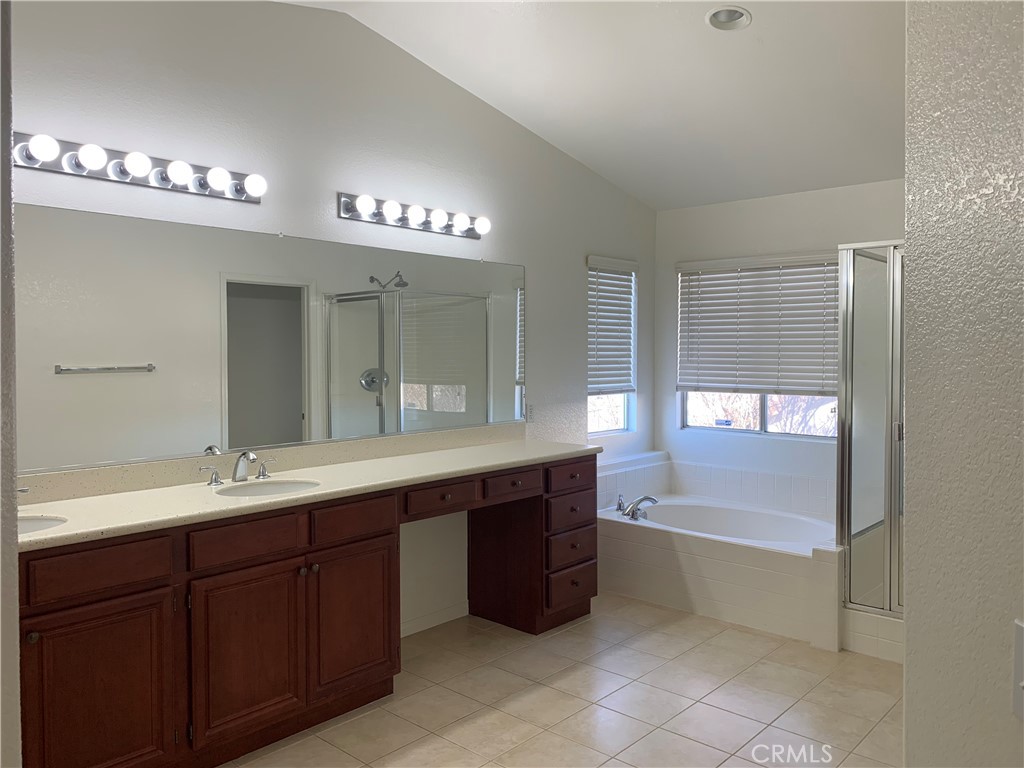 33782 Channel Street Temecula, CA 92592 - Photo 20 of 30 a spacious bathroom with a double vanity sink a large mirror and a bathtub
