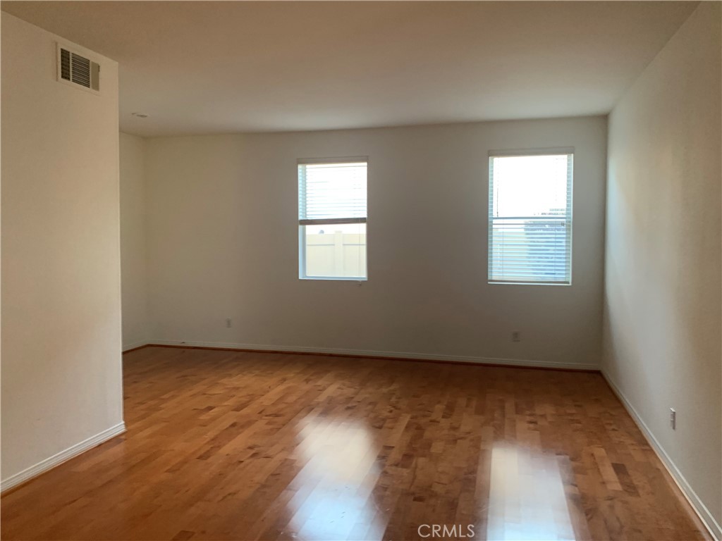33782 Channel Street Temecula, CA 92592 - Photo 2 of 30 a view of an empty room with wooden floor and a window