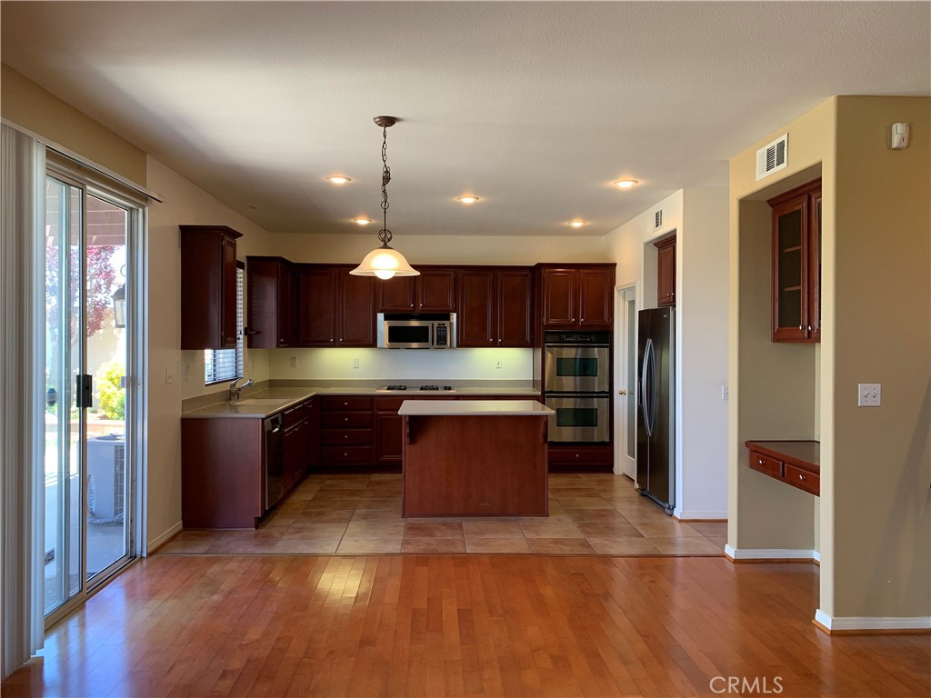 33782 Channel Street Temecula, CA 92592 - Photo 4 of 30 a large kitchen with a large center island and stainless steel appliances