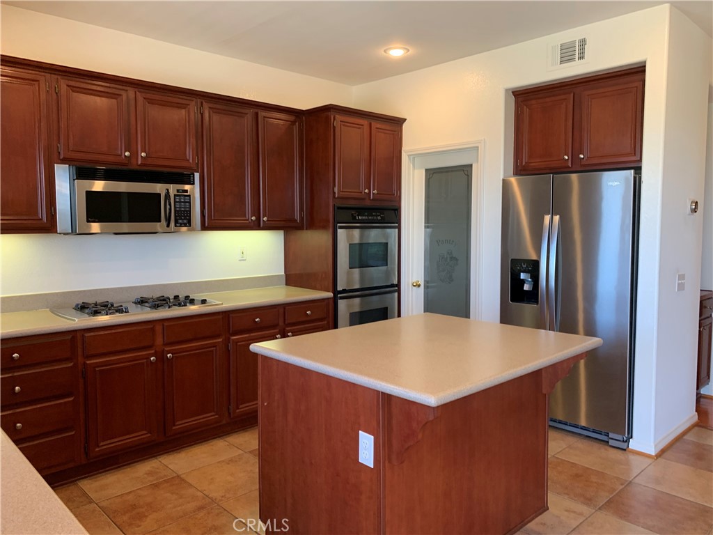 33782 Channel Street Temecula, CA 92592 - Photo 6 of 30 a kitchen with stainless steel appliances wooden cabinets and granite counter tops