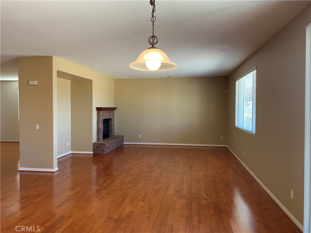 33782 Channel Street Temecula, CA 92592 - Photo 7 of 30 a view of an empty room with wooden floor and a window