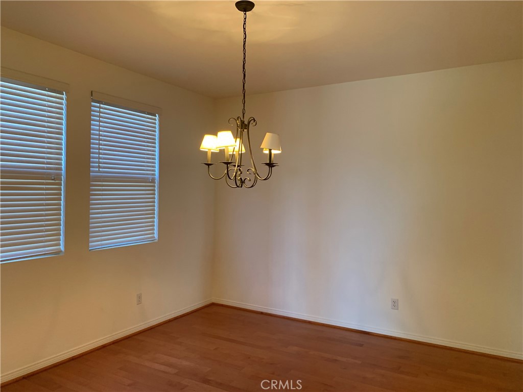 33782 Channel Street Temecula, CA 92592 - Photo 9 of 30 a view of a room with wooden floor and chandelier