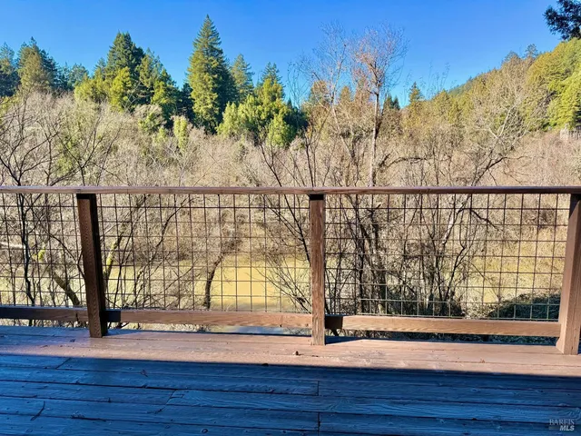a balcony with wooden floor and outdoor seating