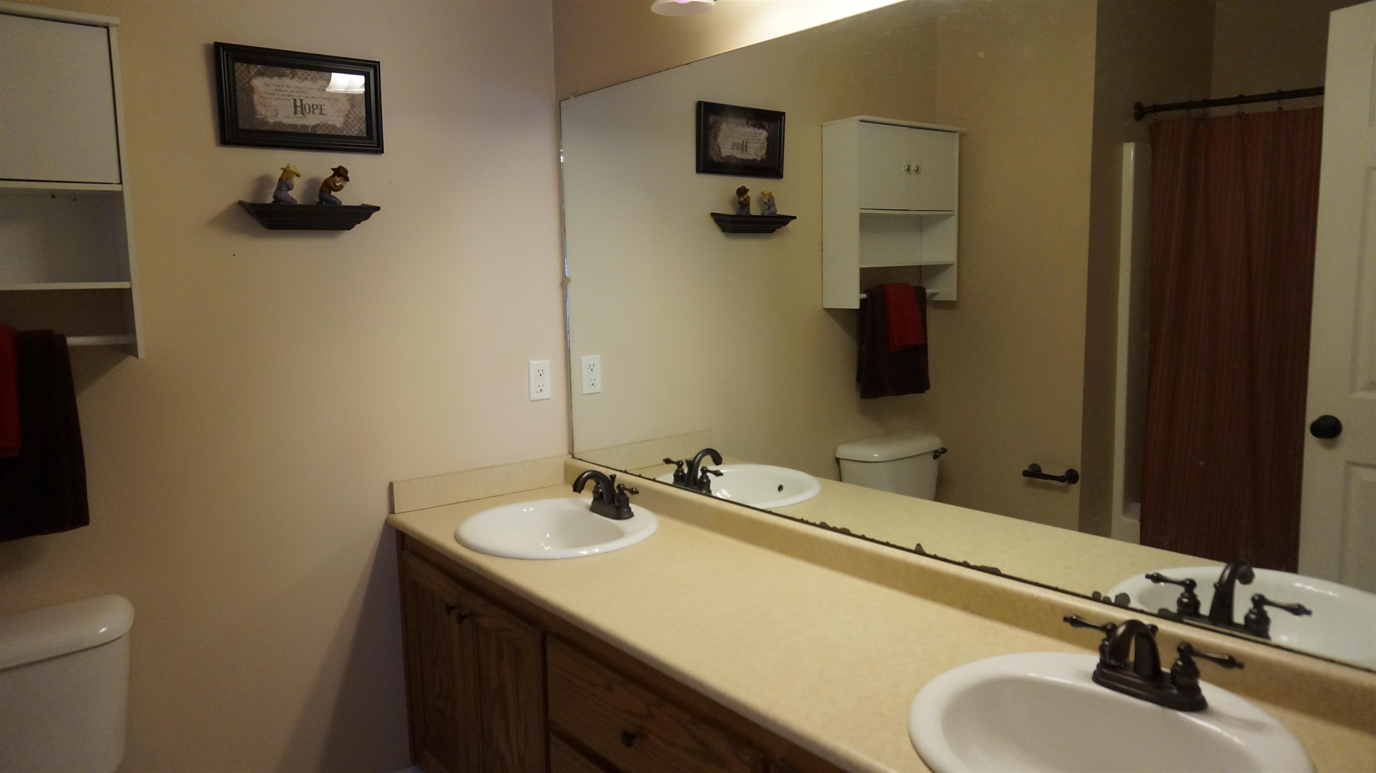 7558 South Swift Road Goodlettsville, TN 37072 - Photo 12 of 18 a bathroom with a sink double vanity and a mirror