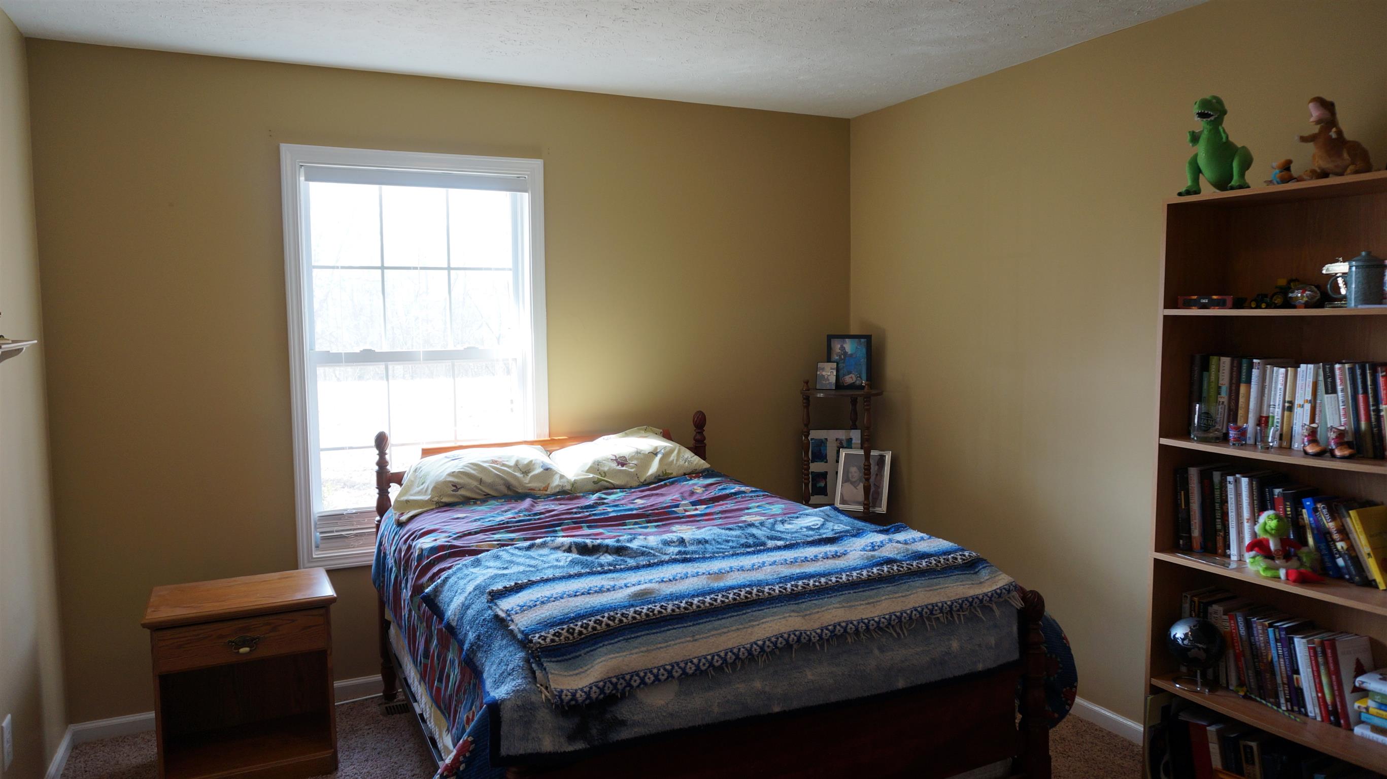 7558 South Swift Road Goodlettsville, TN 37072 - Photo 13 of 18 a bedroom with a bed and a bookshelf