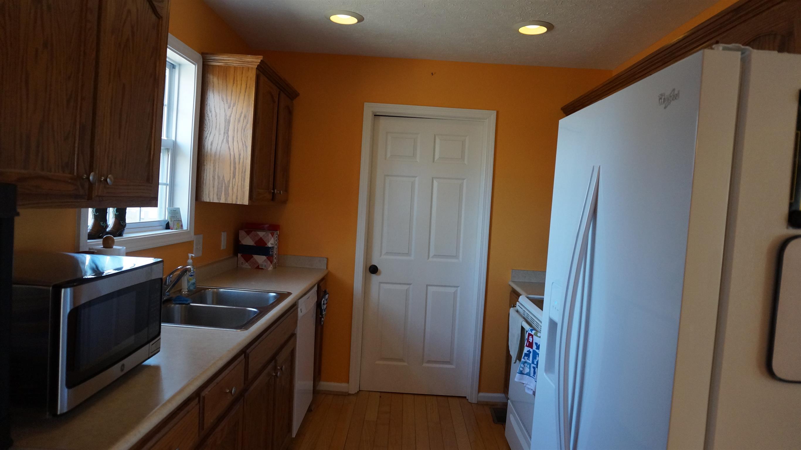 7558 South Swift Road Goodlettsville, TN 37072 - Photo 8 of 18 a kitchen with a sink and a refrigerator