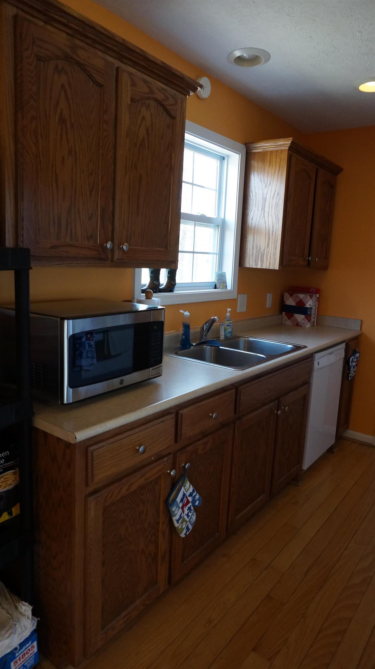 7558 South Swift Road Goodlettsville, TN 37072 - Photo 9 of 18 a kitchen with granite countertop a sink cabinets and window