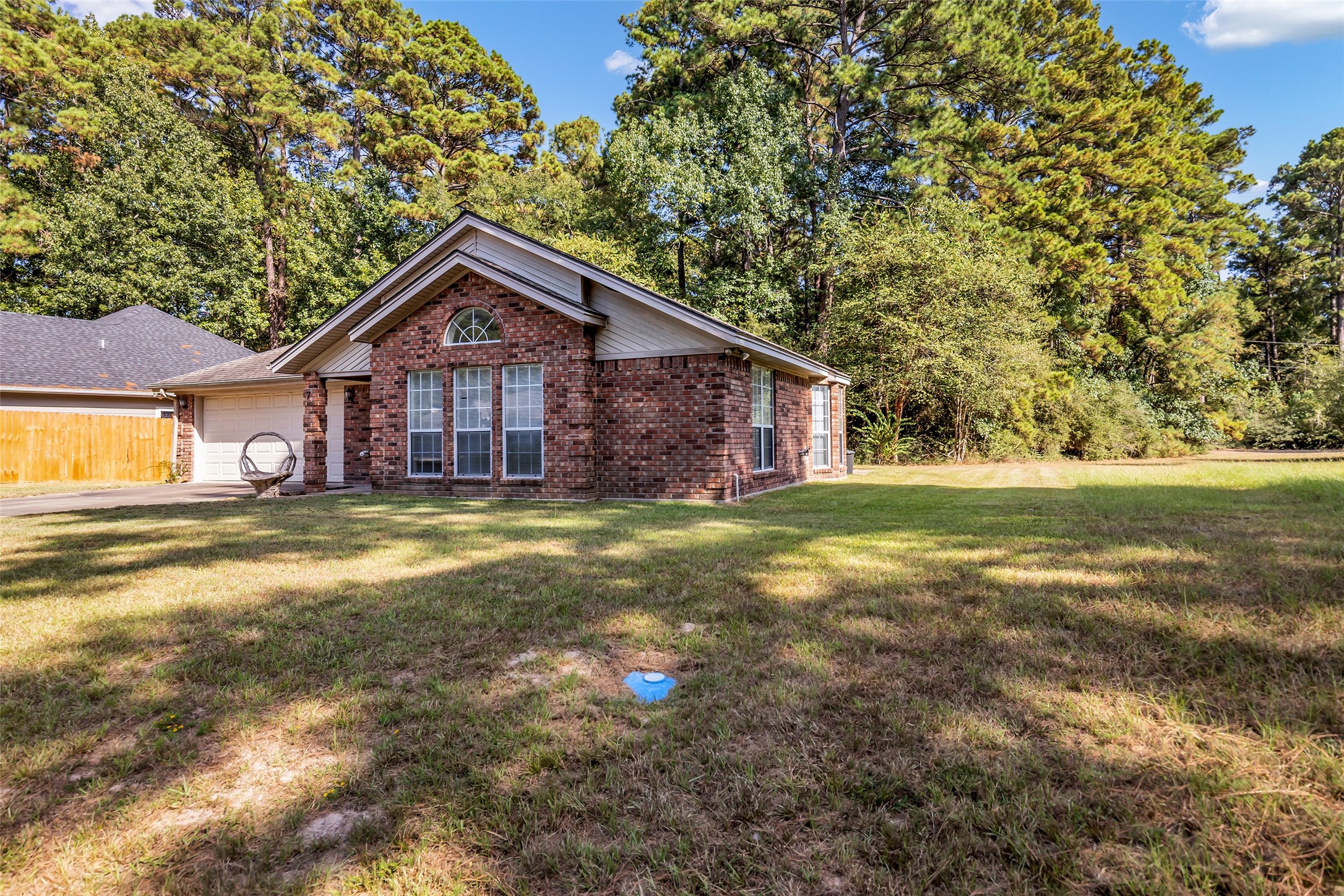 7 Lazy Spring Trinity, TX 75862 - Photo 24 of 25 Welcome home to this charming property featuring inviting curb appeal, mature landscaping, and a classic brick exterior.