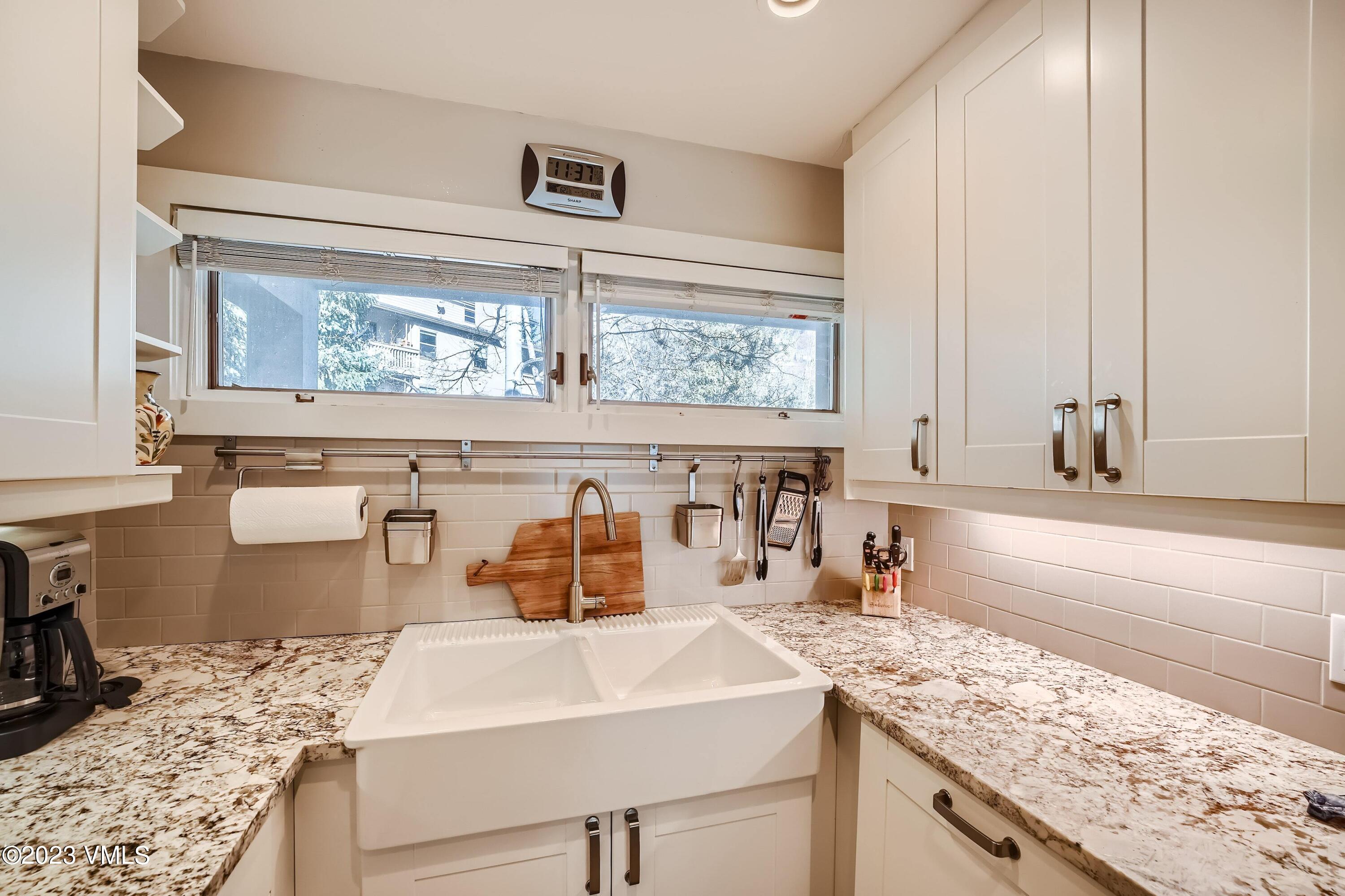 1030 Lions Ridge Loop, Unit 202 Vail, CO 81657 - Photo 11 of 25 a kitchen with a sink stove and cabinets