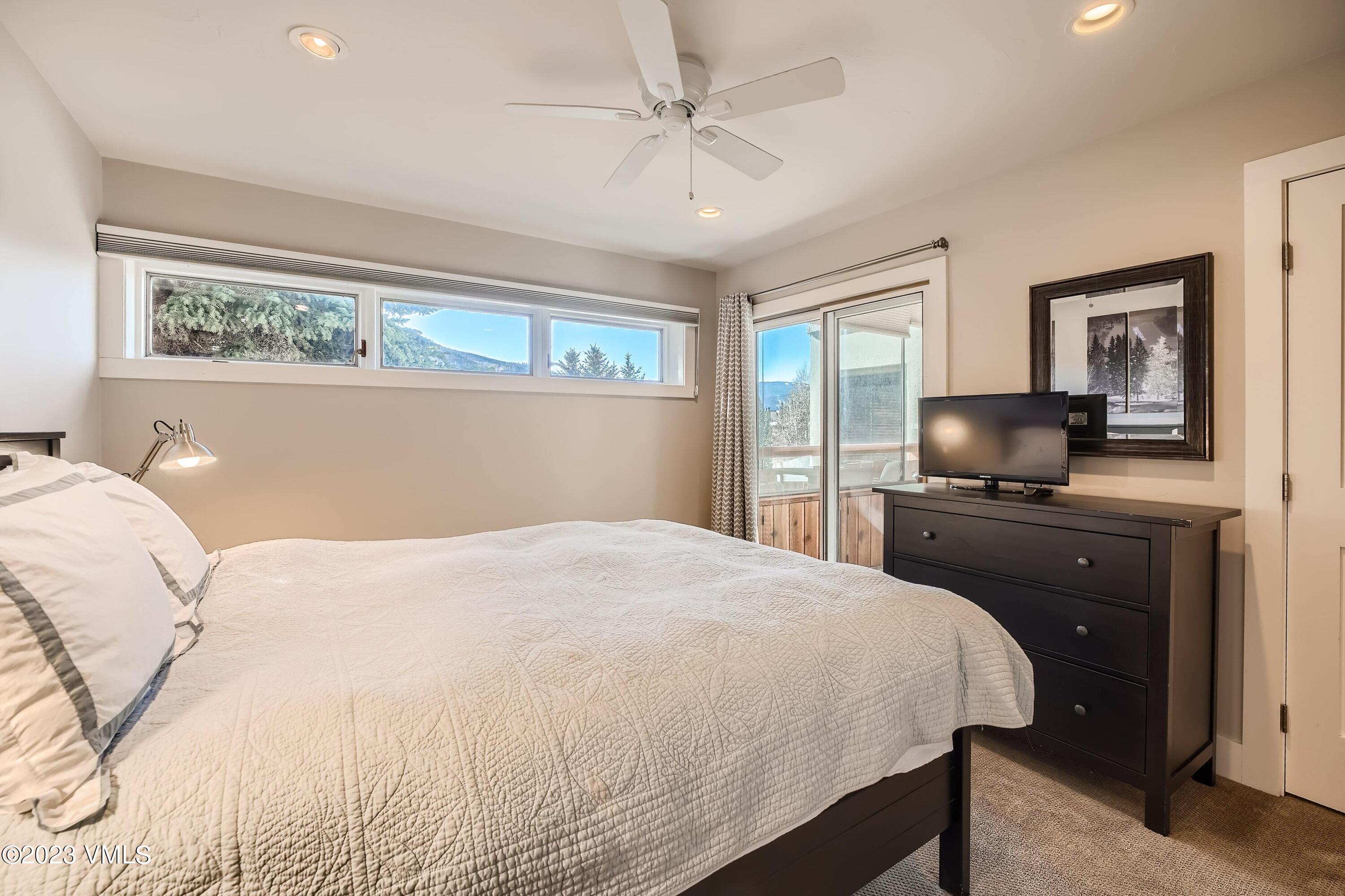 1030 Lions Ridge Loop, Unit 202 Vail, CO 81657 - Photo 12 of 25 a bedroom with a bed and a window