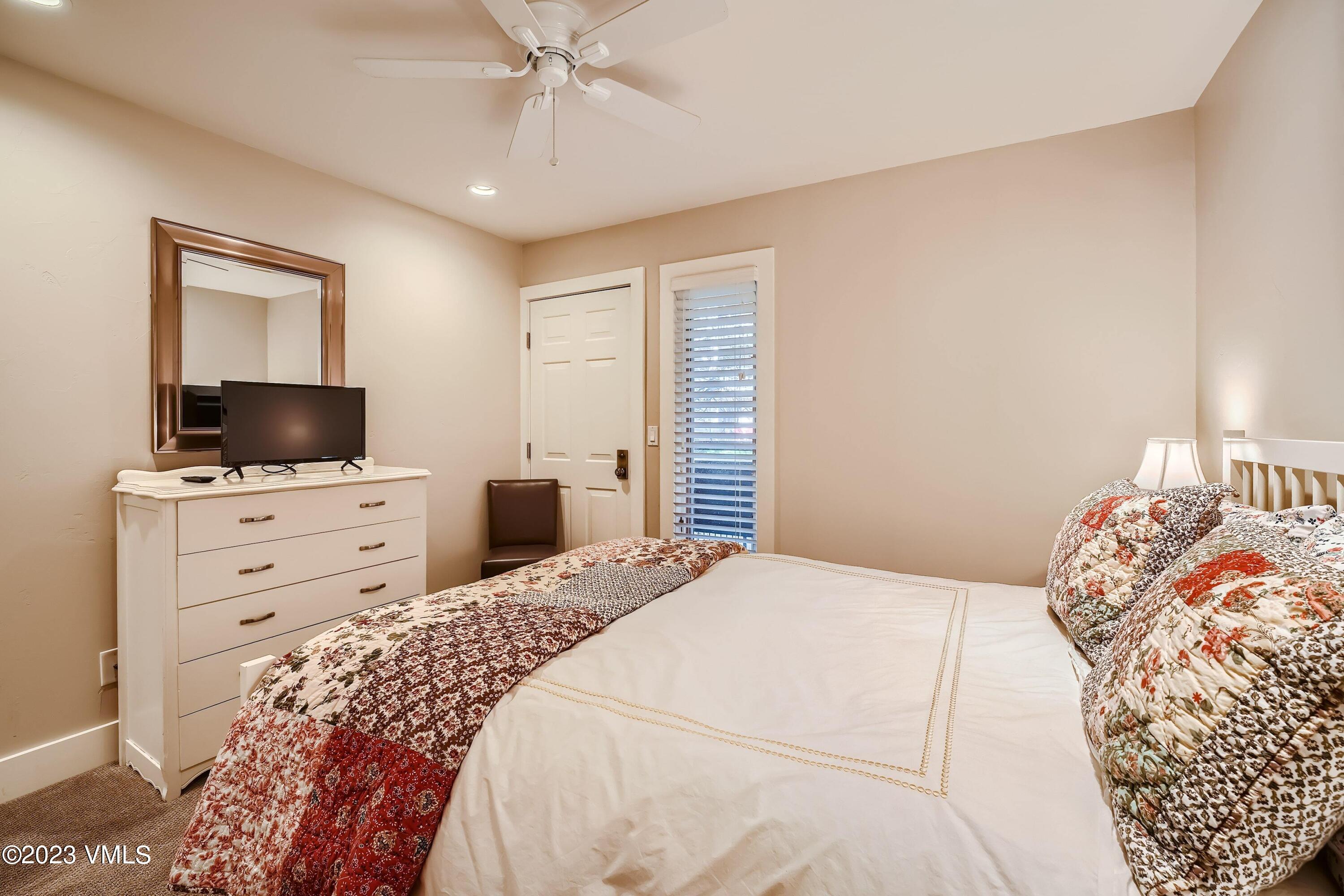 1030 Lions Ridge Loop, Unit 202 Vail, CO 81657 - Photo 16 of 25 a bedroom with a bed and a flat screen tv