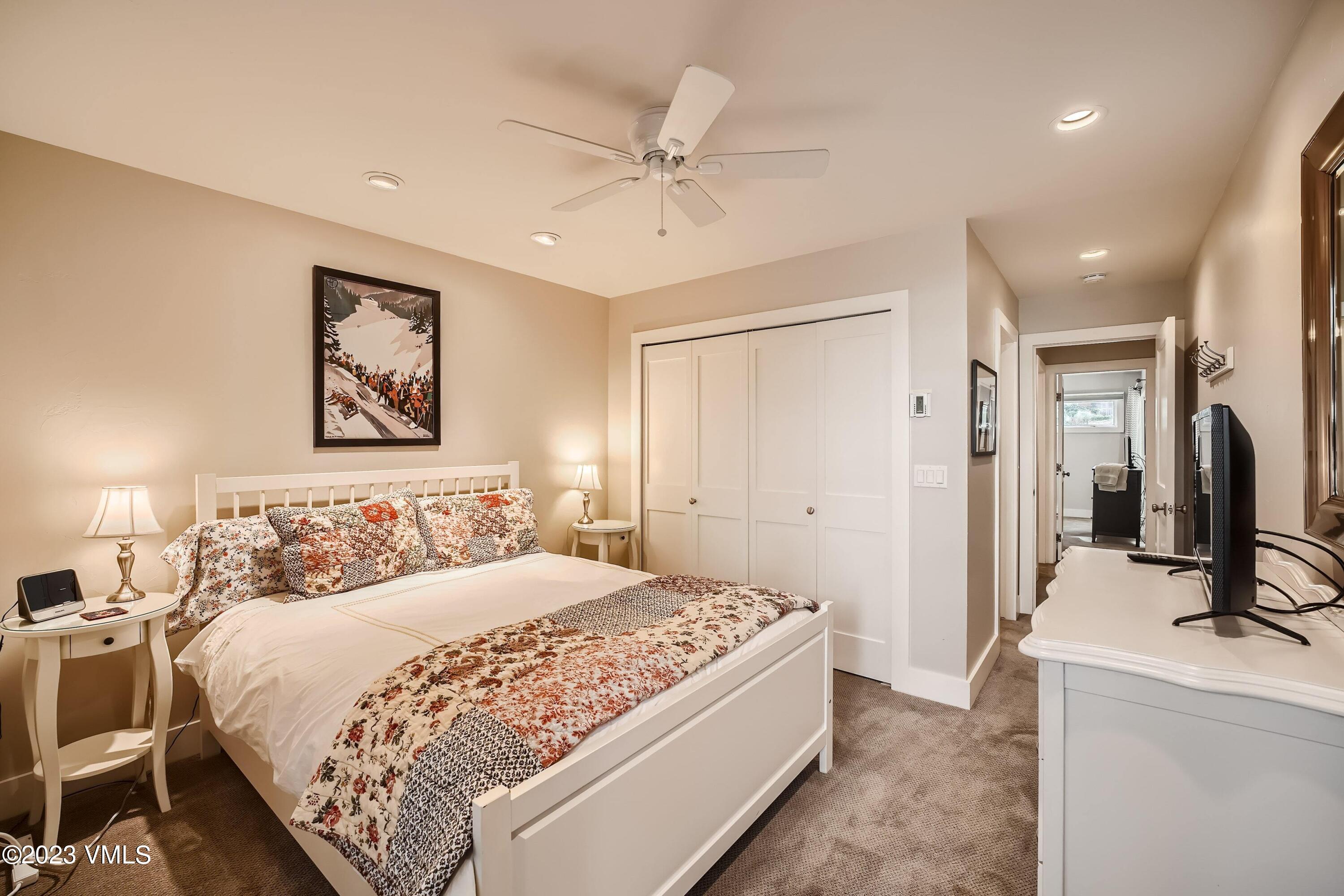 1030 Lions Ridge Loop, Unit 202 Vail, CO 81657 - Photo 17 of 25 a bedroom with a large bed and a chandelier