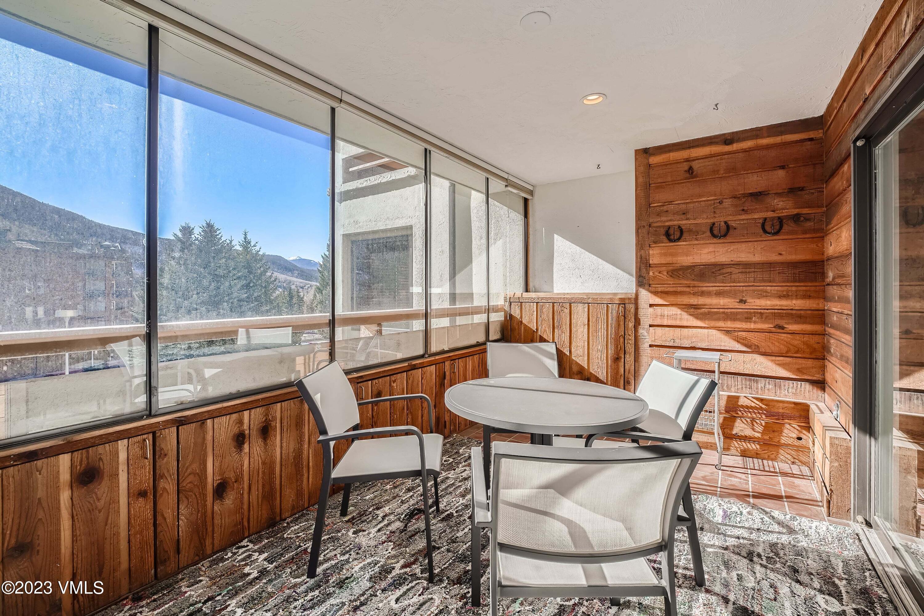 1030 Lions Ridge Loop, Unit 202 Vail, CO 81657 - Photo 20 of 25 a balcony with table and chairs