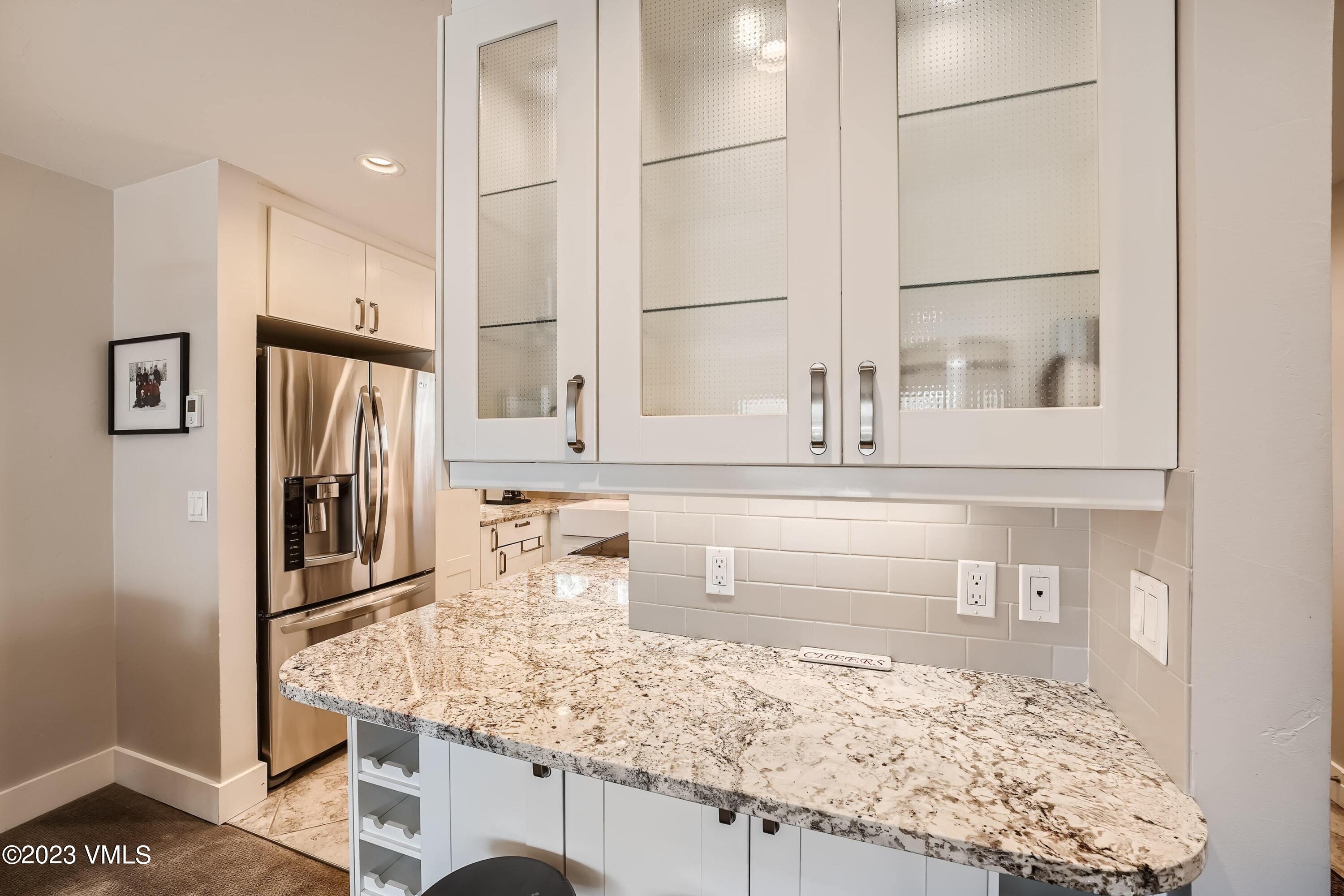 1030 Lions Ridge Loop, Unit 202 Vail, CO 81657 - Photo 8 of 25 a kitchen with a refrigerator and countertop