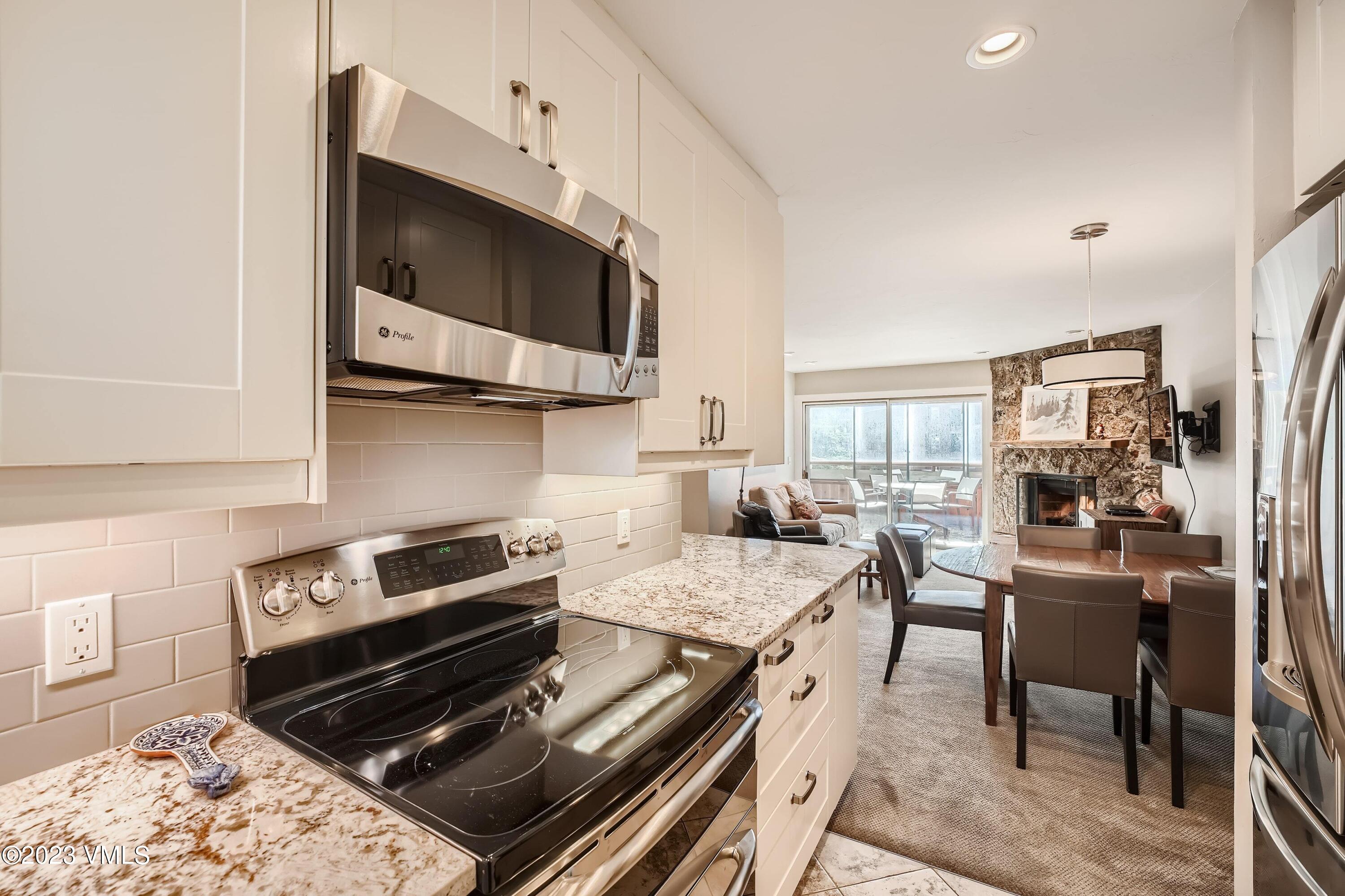 1030 Lions Ridge Loop, Unit 202 Vail, CO 81657 - Photo 9 of 25 a kitchen with a stove and a microwave
