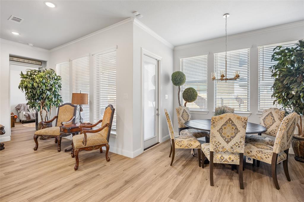 2628 Flycatcher Road Fort Worth, TX 76118 - Photo 14 of 38 Dining room featuring ornamental molding, light wood-type flooring, and a chandelier