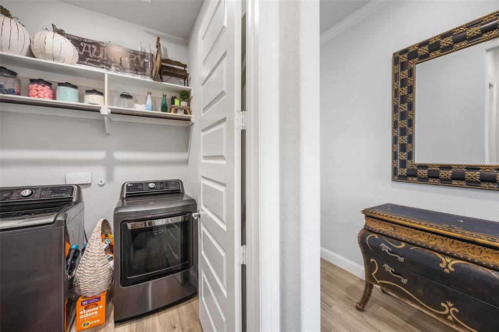 2628 Flycatcher Road Fort Worth, TX 76118 - Photo 15 of 38 Laundry room with light wood finished floors, crown molding, and washer and dryer