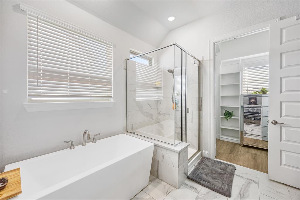2628 Flycatcher Road Fort Worth, TX 76118 - Photo 20 of 38 Bathroom with marble finish flooring, a freestanding bath, a spacious closet, a shower stall, and recessed lighting