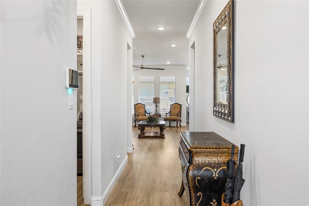 2628 Flycatcher Road Fort Worth, TX 76118 - Photo 3 of 38 Corridor with light wood finished floors, recessed lighting, and ornamental molding