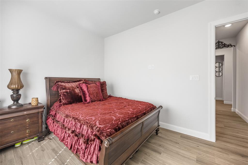 2628 Flycatcher Road Fort Worth, TX 76118 - Photo 27 of 38 Bedroom with light wood finished floors and baseboards