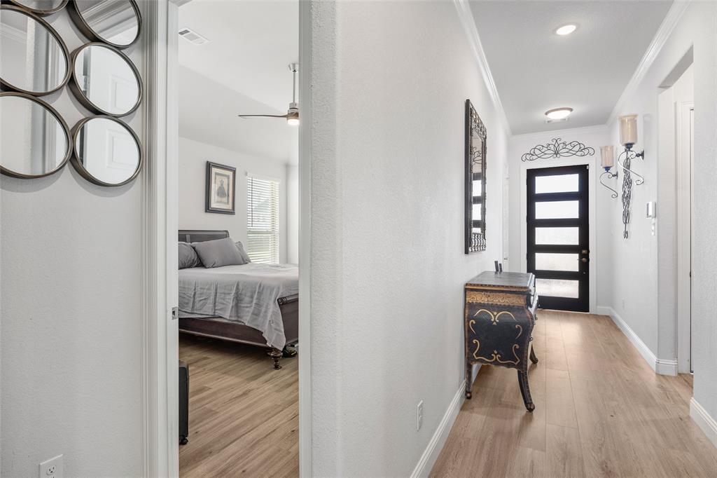 2628 Flycatcher Road Fort Worth, TX 76118 - Photo 4 of 38 Corridor featuring crown molding, light wood-style flooring, and a textured wall
