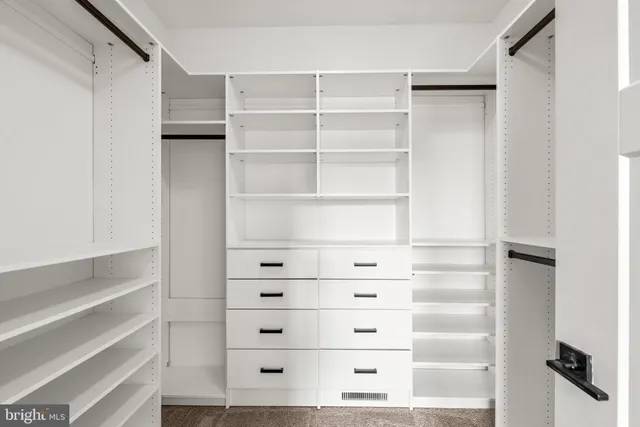 a bathroom with a double vanity sink toilet and shower