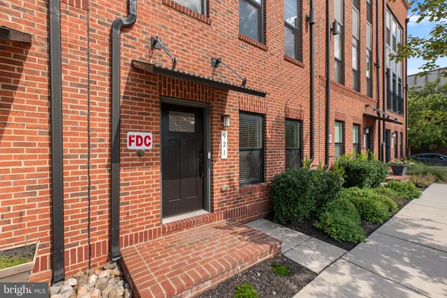 a front view of a building with a garden