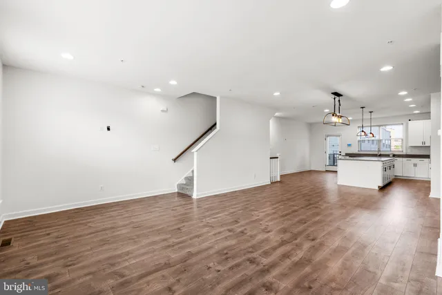 a view of kitchen with wooden floor and windows