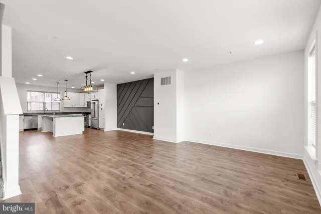 a view of kitchen with kitchen island and stainless steel appliances