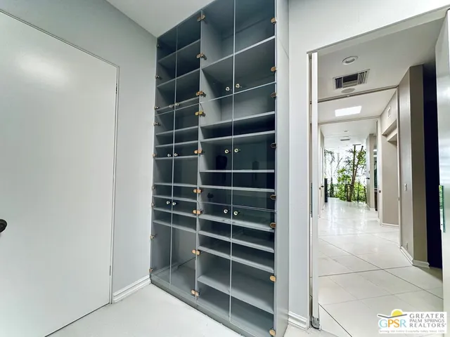 a view of walk in closet with empty racks